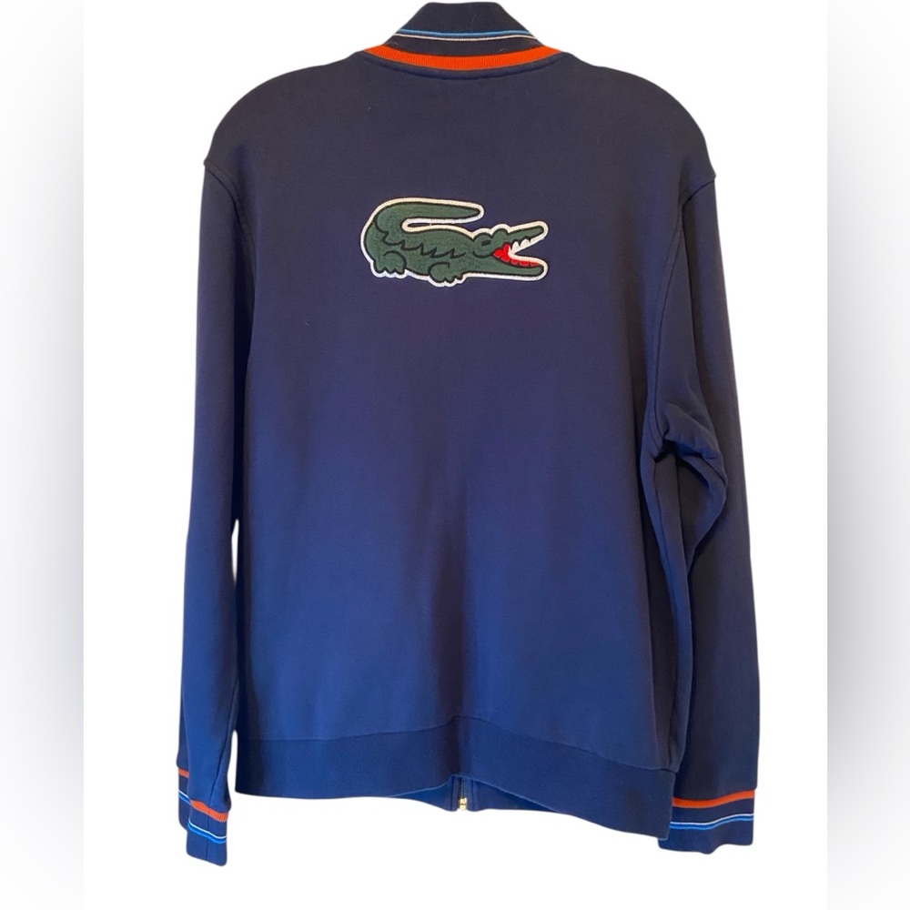Lacoste navy zip-up jacket with a large embroidered crocodile logo on the back